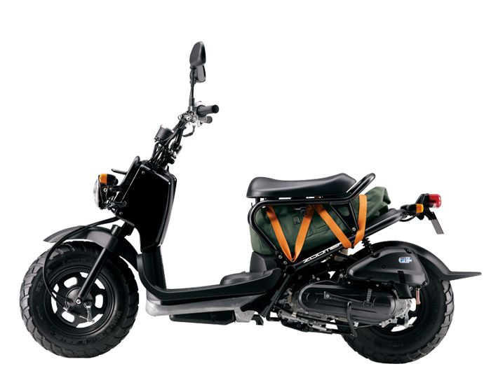 a scooter is parked on a white background with the seat folded down and it's cargo bag attached to the back