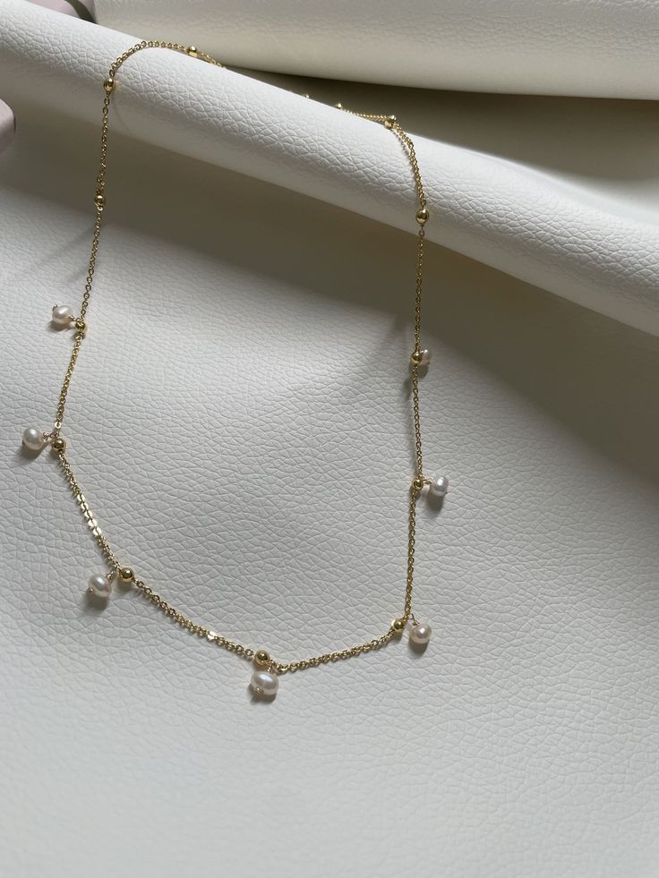 This necklace is handcrafted in brass with an elegant touch with the precious pearl charm attached. It's so minimalist but sophisticated, elegant but classy, simple but unique! It can match almost everything in your closet! //Materials// ✔️ pearl  ✔️ Chain, brass //Necklace Length// 18"  //Special Notes// **Feel free to ask me anything if you have concerns ! Fresh water pearl Gold Clavicle Chain 14k Gold Pearl Necklace, Delicate Yellow Gold Necklaces With Pearl Charm, Gold Plated Drop Jewelry With Pearl Charm, Gold Clavicle Chain Pearl Necklace In 14k Gold, Gold 14k Gold Clavicle Chain Pearl Necklace, 14k Gold Pearl Clavicle Necklace, 14k Gold Pearl Drop Pendant Necklace, Delicate 14k Gold Pearl Drop Necklace, Gold Minimalist Dangle Necklaces