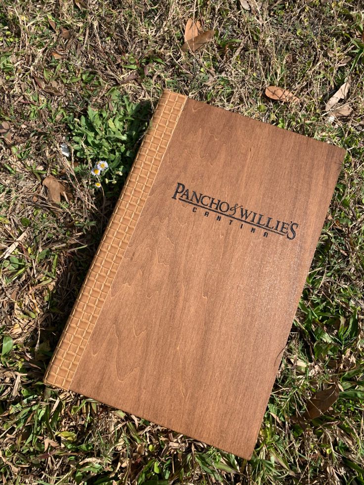 a book that is laying on the ground in the grass with words pancho willie's written on it