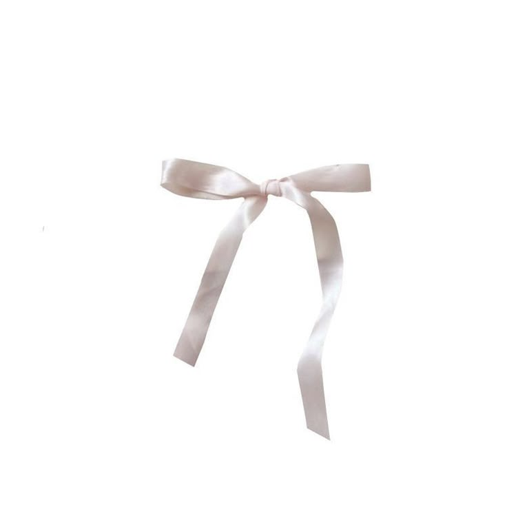 a white ribbon tied to the side of a wall with a bow on it's end