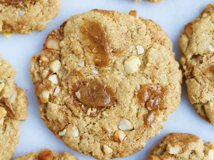 cookies with nuts are arranged on a white surface