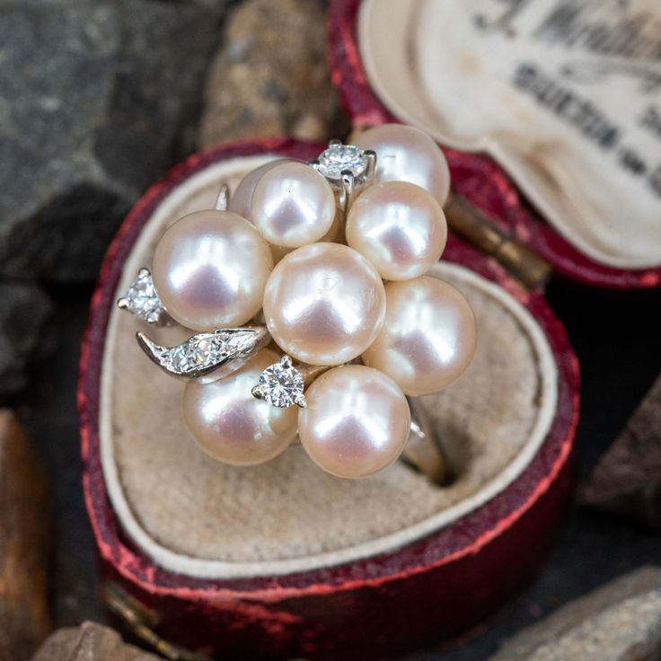 This prominent cluster style ring is accented with nine (9), post set, cultured saltwater pearls, three (3), prong set, round brilliant cut diamonds and four (4), bead set, round single cut diamonds. The ring measures 21.9mm at the top, rises 14.5mm above the finger, tapering to 1.7mm wide and 1.1mm thick at the base of the shank. This ring is currently a size 5.25. Luxury Pearl Gemstone Ring For Anniversary, Pearl Cluster Ring, Antique Cocktail Ring, Jewel Of The Seas, Pearl Love, Saltwater Pearls, Pearl Cluster, Aquamarine Jewelry, Pearl Diamond