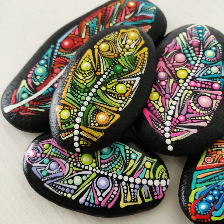 several painted rocks sitting on top of a table