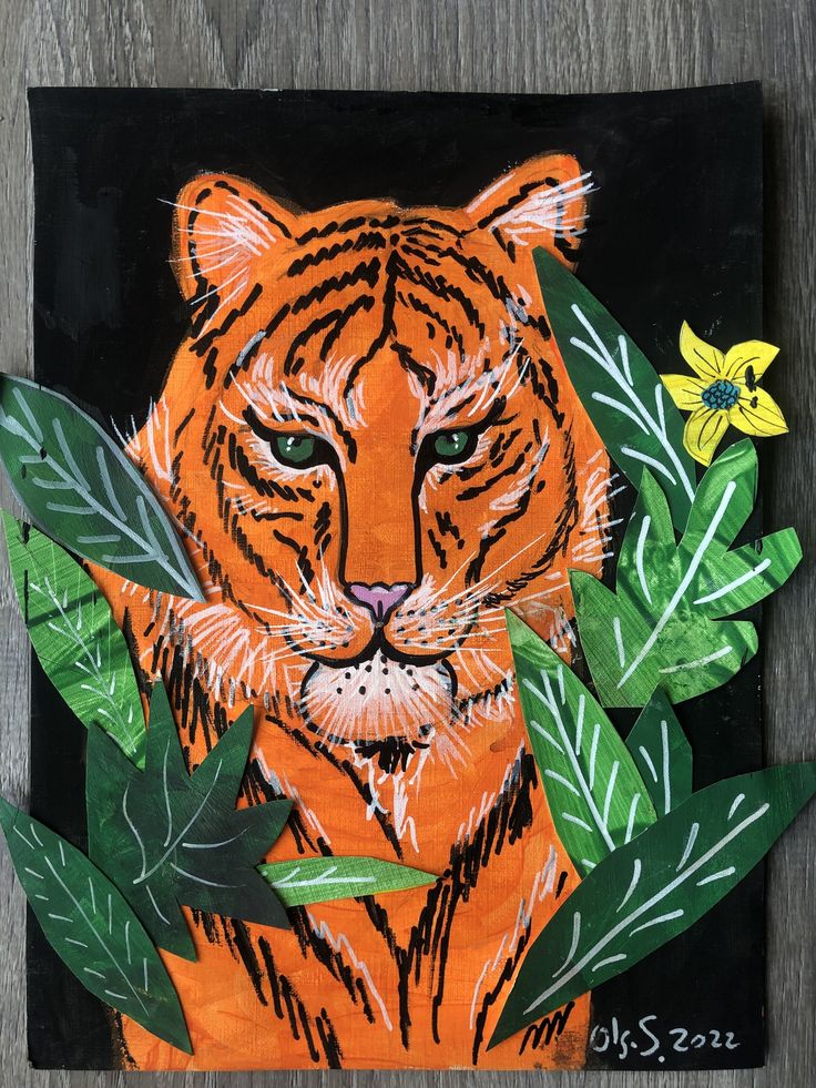 an orange tiger surrounded by green leaves and flowers