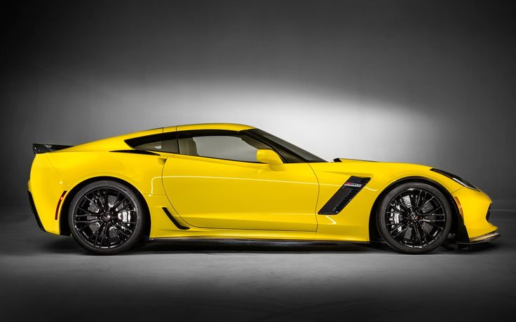 a yellow sports car is shown in the dark