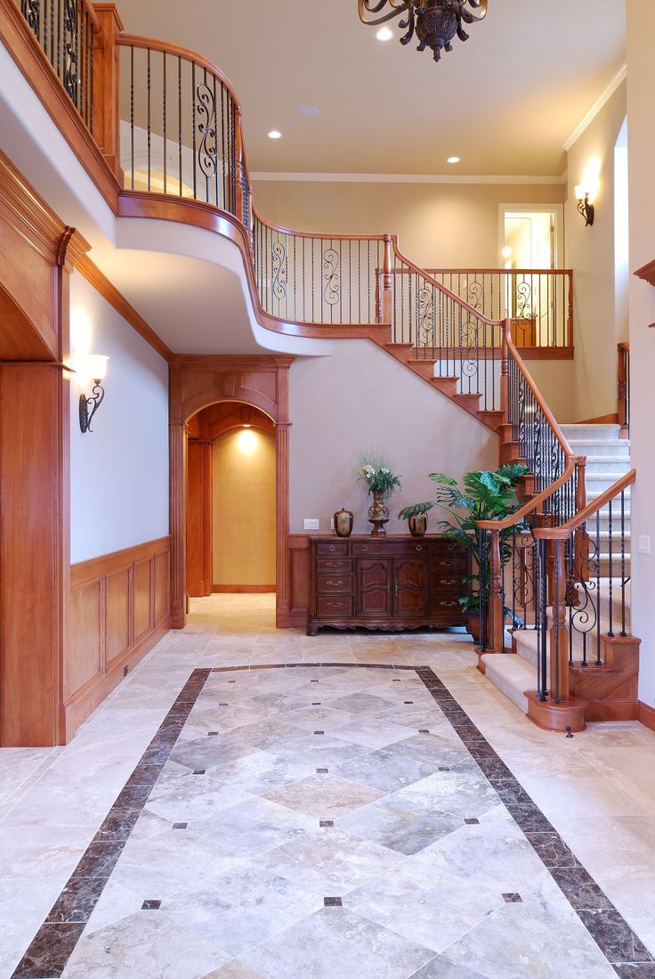 a large foyer with stairs leading up to the second floor