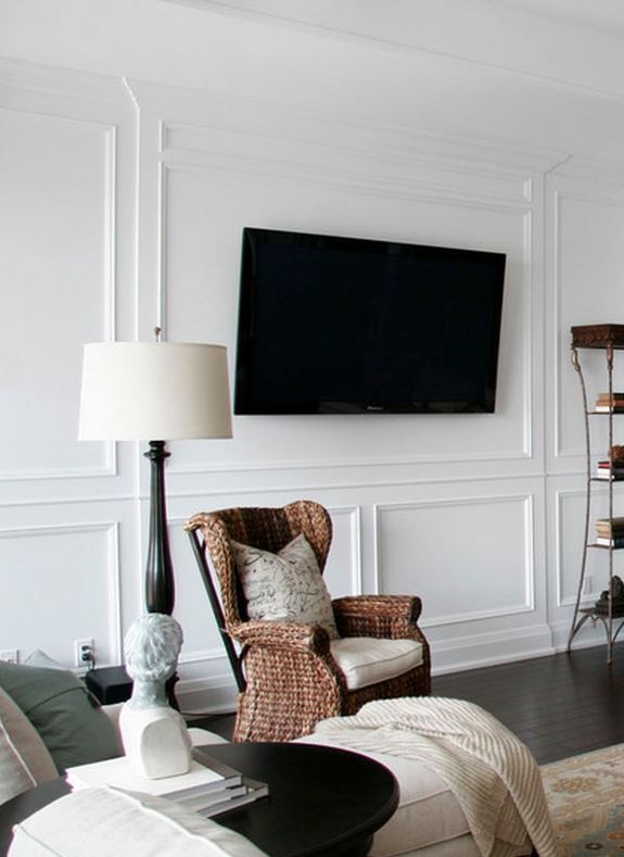 a living room filled with furniture and a flat screen tv mounted on the wall over a fireplace