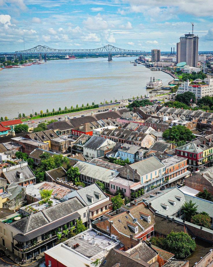 an aerial view of a city with bridges in the background