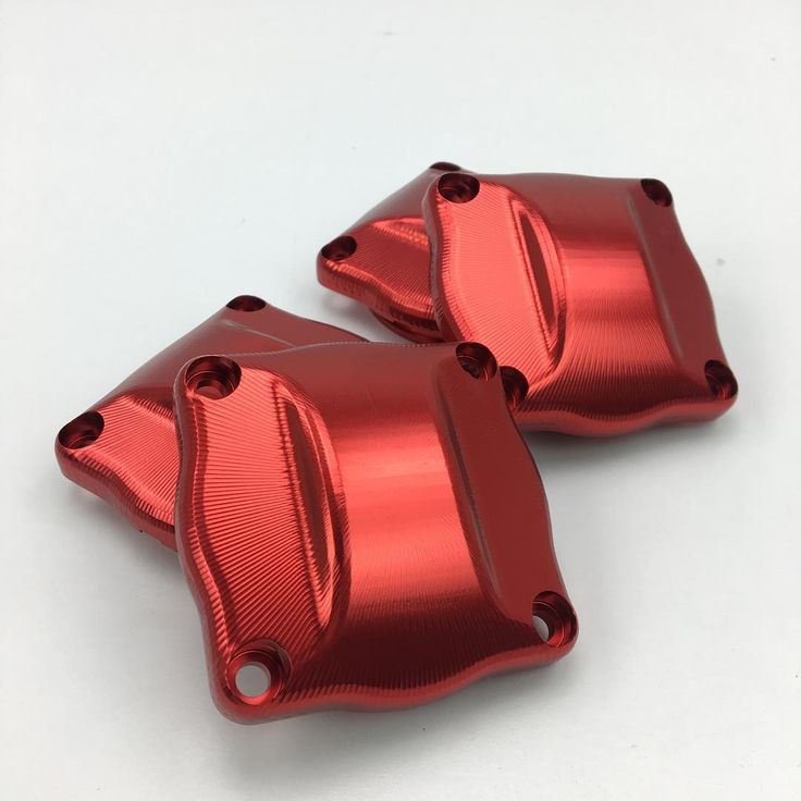 pair of red aluminum brake covers on white background