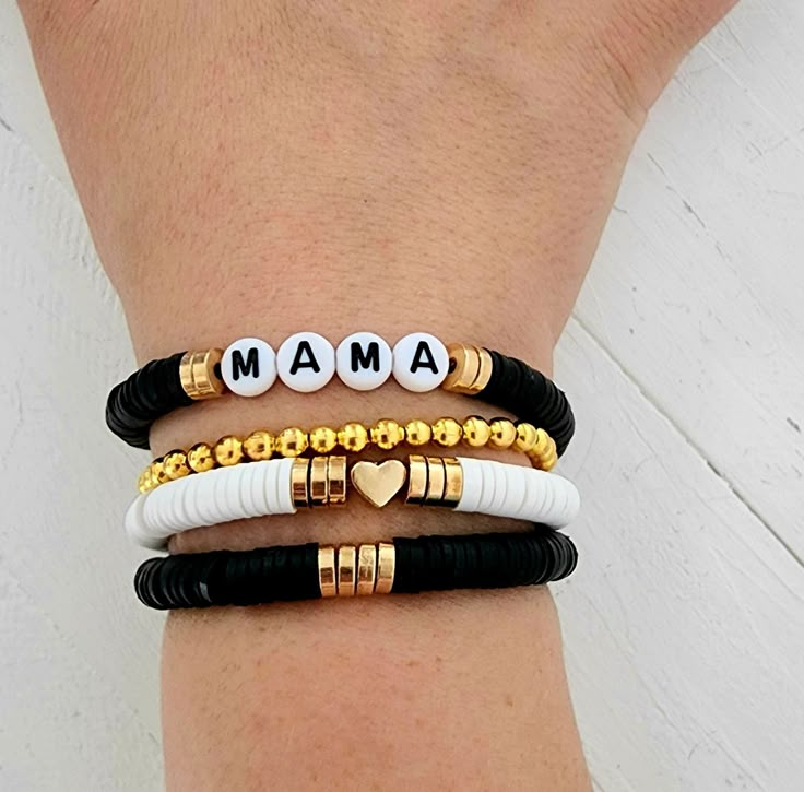 This is a super cute and fun stack of bracelets accented with black and gold heishi beads you are sure to love. Personalize with a name or names of your choice add a heart or filler bracelet to complete your stack! Great gift for any women or girls! Give mama a gift for Mother's Day! You may choose to have a single name bracelet 1 single filler bracelet or if choosing multiple bracelets, you can choose 2 names or 1 name and a filler or 3 names if choosing 3 bracelets and so on. How to order 1) S Clay Bead Bracelet For Mom, Momma Clay Bead Bracelet, Mom Heishi Bracelet, Clay Bead Bracelet Ideas Mama, Stacked Heishi Bracelets, Mother’s Day Diy Bracelets, Mama Heishi Bracelet, Mothers Day Clay Bead Bracelet Ideas, Clay Bead Bracelets For Moms