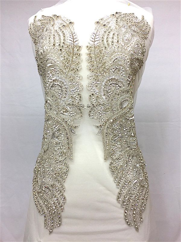 a white dress with silver beading on it