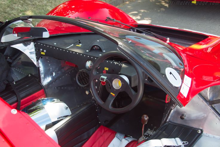 the interior of a red sports car is shown