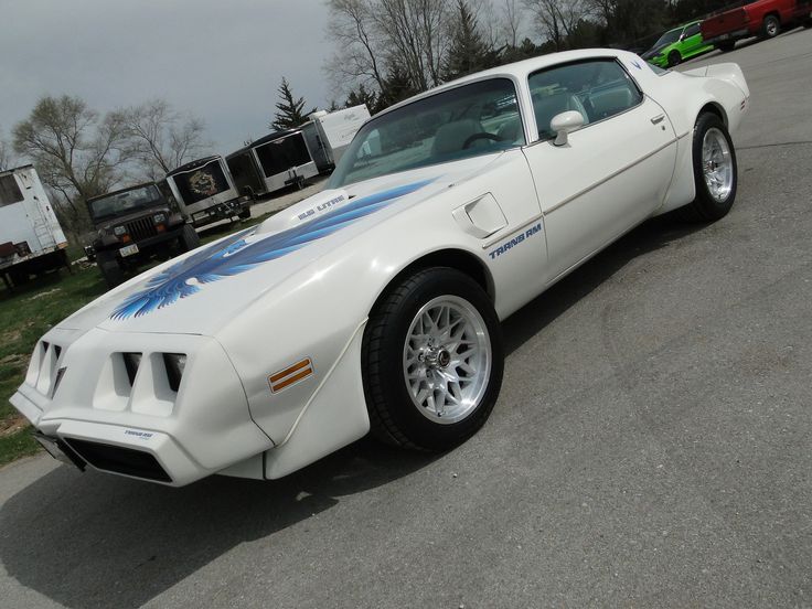 a white sports car parked in a parking lot