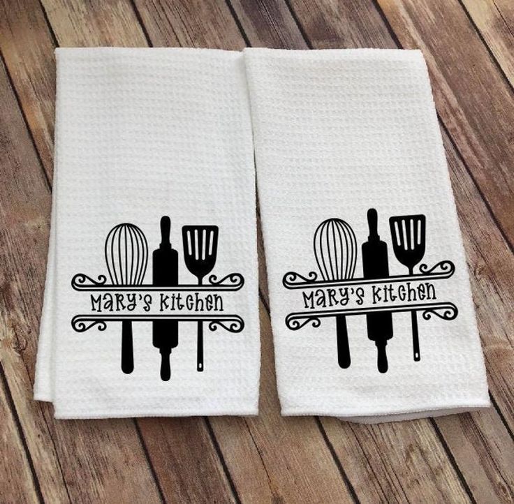 two kitchen towels with black and white designs on them