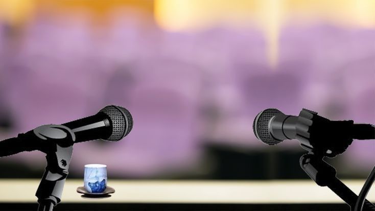 two microphones sitting next to each other on top of a table in front of a purple background