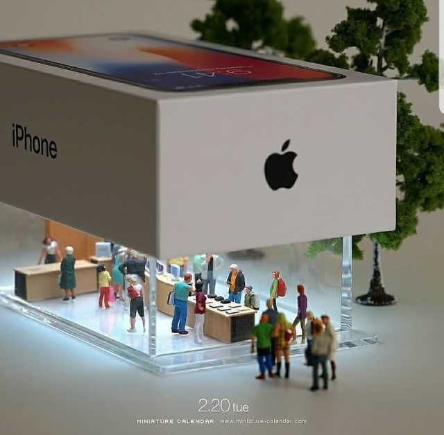 an apple store with people standing around and looking at the iphone in it's display case