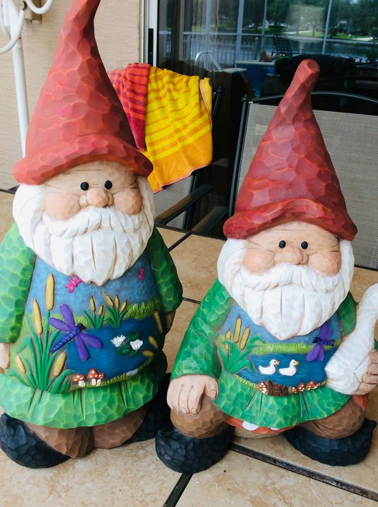 two garden gnomes sitting next to each other