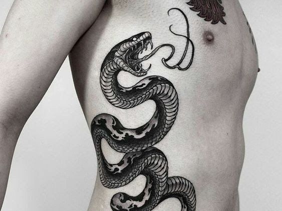 a man with a tattoo on his stomach has a black snake tattooed on it's side