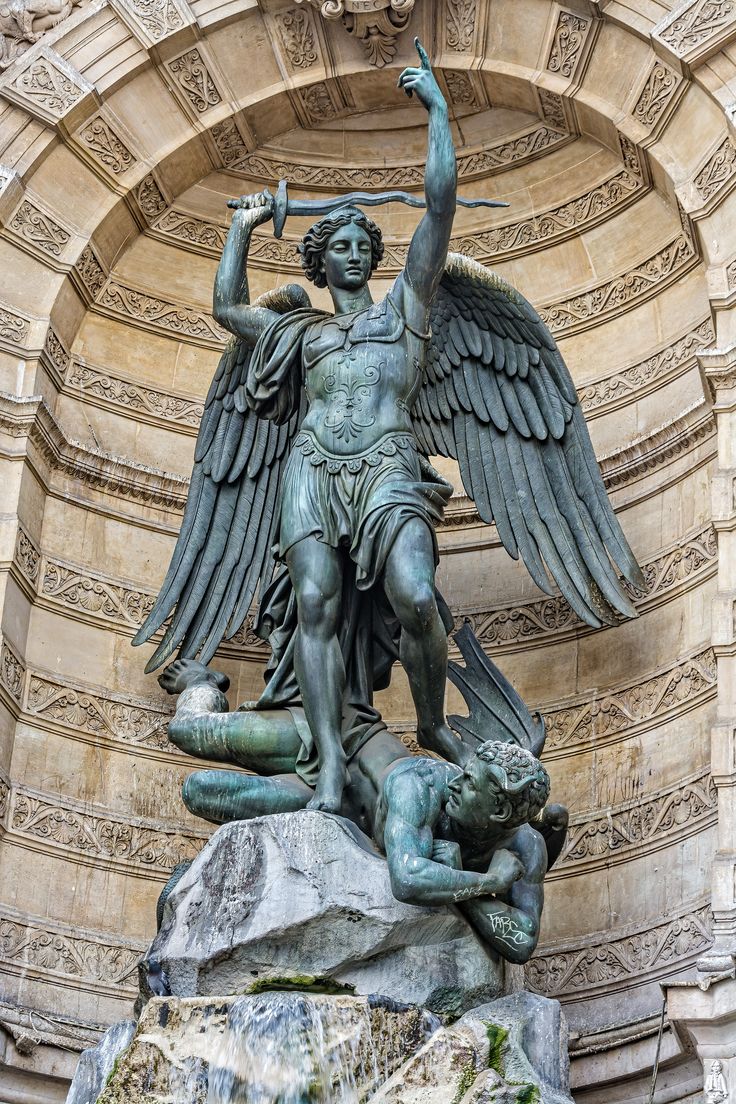 an angel statue on the side of a building