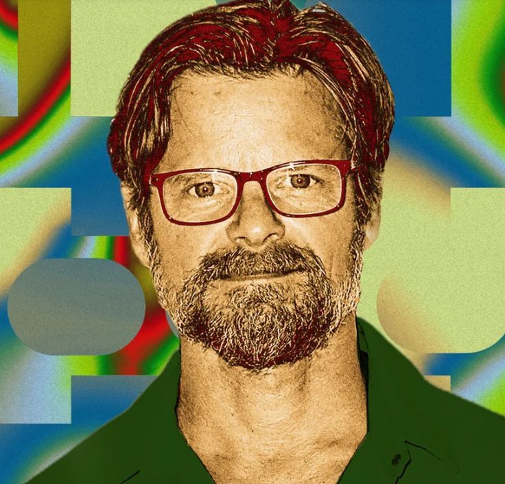 a man with glasses and a beard in front of an abstract background that looks like he is looking at the camera