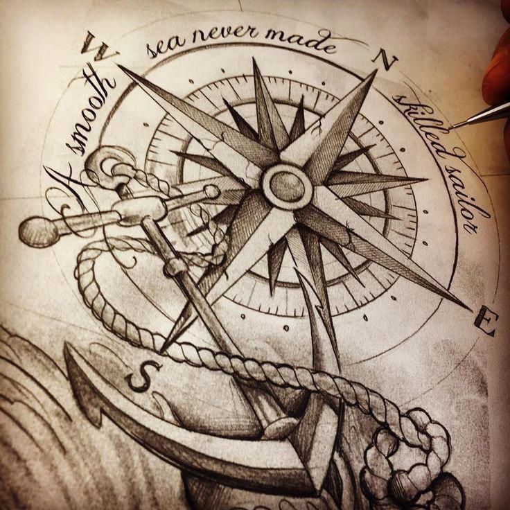 a drawing of an anchor and compass on paper