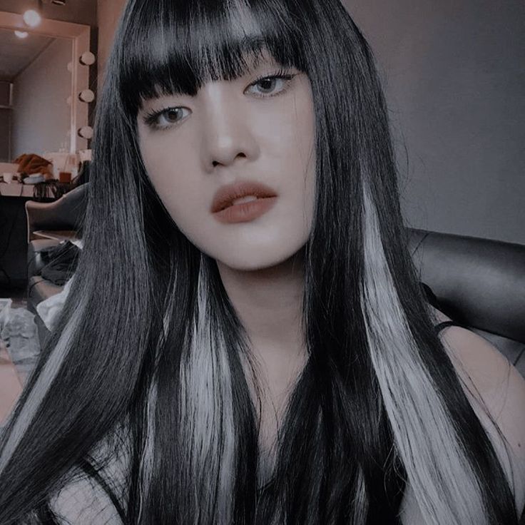 a woman with long black hair and bangs