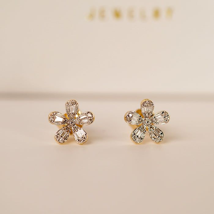 Celebrate Mother's Day with an unforgettable offer! Don't miss out on this special opportunity! Diamond flower earrings are a captivating jewelry design that often showcases the brilliance of diamonds in a floral-inspired motif. Design: Diamond flower earrings feature a central diamond or cluster of diamonds arranged in the shape of a flower. The design can vary from delicate and understated to bold and intricate, depending on the size and arrangement of the diamonds. Diamonds: The diamonds used in these earrings are usually of high quality, chosen for their clarity, cut, and brilliance. They may be round, princess, pear, marquise, or any other cut that mimics the petals of a flower. The diamonds may be set in prongs, bezels, or pavé settings to create the desired floral effect. Floral Mot Diamond Flower Earrings, Motif Design, Pave Setting, Diamond Flower, Gold Collection, Flower Earrings, Floral Motif, A Flower, Diamond Jewelry