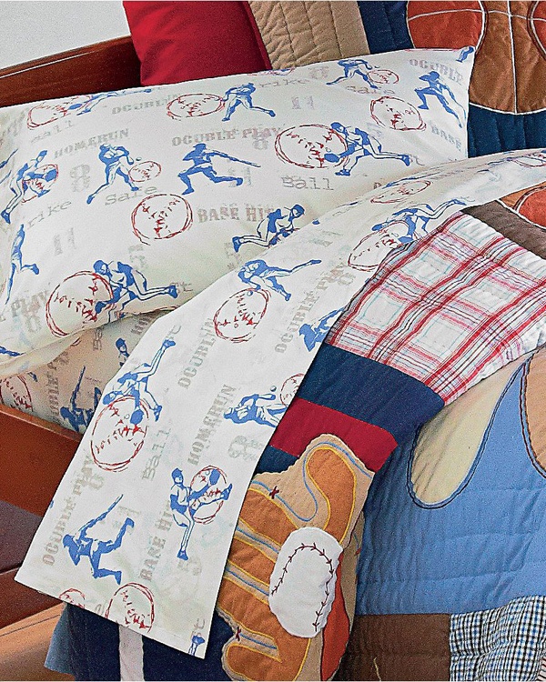 a baseball themed comforter set on a bed