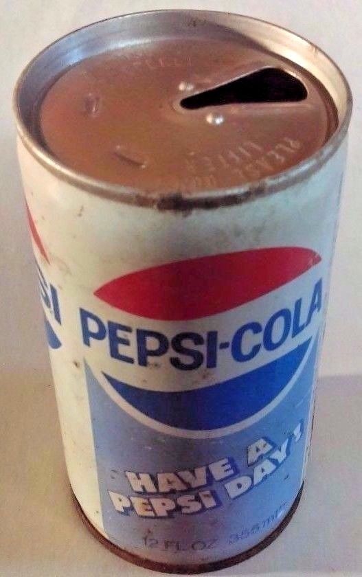 a can of pepsi - cola on a white surface