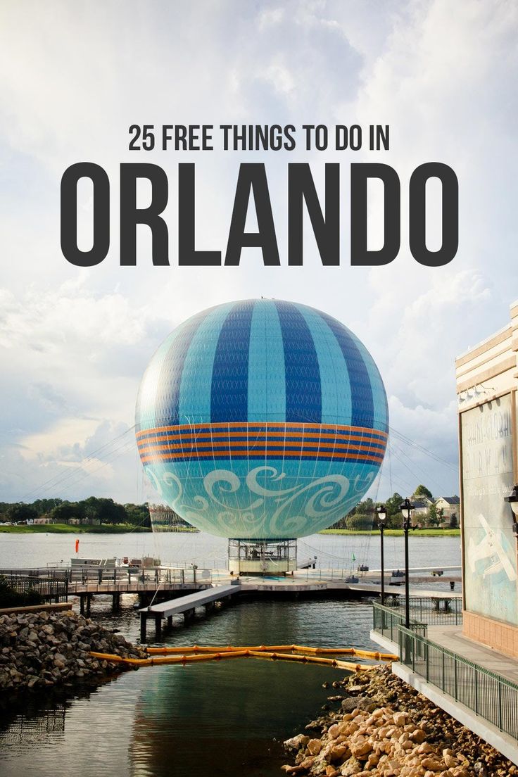 a large blue and white hot air balloon sitting on top of a body of water