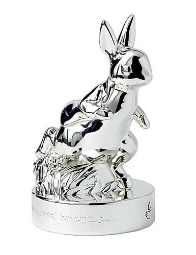 a silver rabbit figurine sitting on top of a white base with an inscription