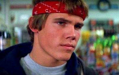 a young man with a bandana on his head