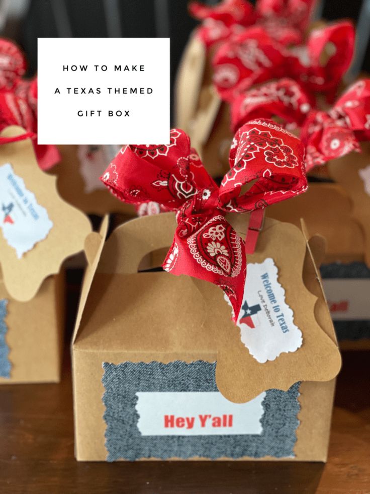 three boxes with red and white bows on them sitting on a table next to each other