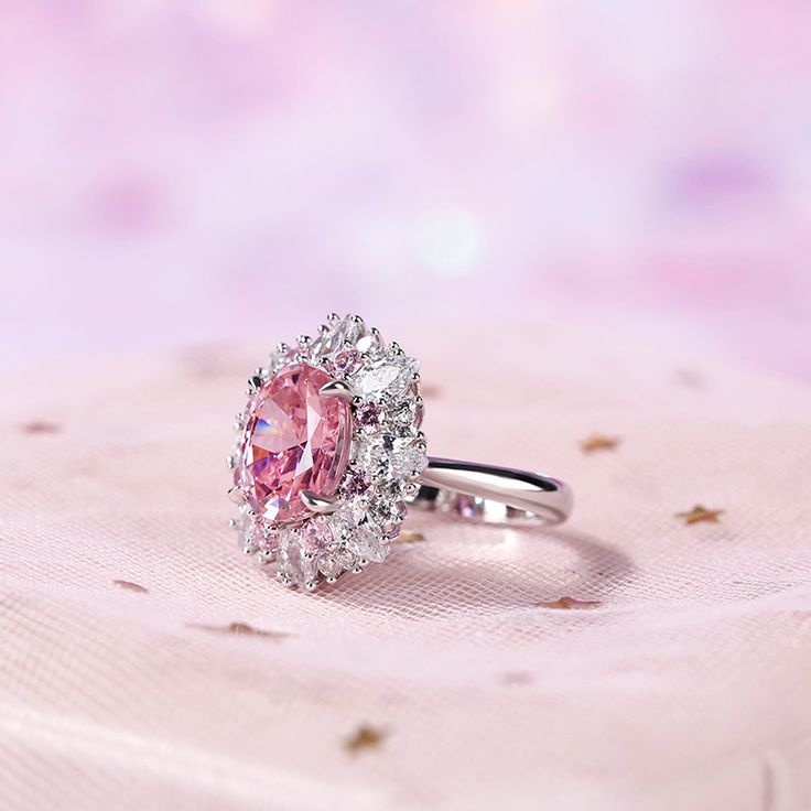 Displaying vivacious feminine flair, this striking fashion ring highlights all that makes her truly exceptional. Crafted in sterling silver, this pretty and unconventional look showcases an oval cut center stone. Pear cut stones, white round stones and pink round stones wrap the centerpiece in a sparkling embrace. Buffed to a brilliant luster, this fabulous conversation piece is sure to be admired often.Carat Weight: 4.95 ctStone Size: 9*11 mmStone Type: Jeulia® StoneNumber of Stones: 1 Stone Color: Fancy PinkStone Shape: OvalCarat Weight: 4.016 ctStone Size: 3*5,1.7,2.4 mmStone Type: Jeulia® StoneNumber of Stones: 32 Stone Color: Diamond White, Fancy PinkStone Shape: Pear, RoundWeight: 7.37 gWidth: 19.2 mmHeight: 8.3 mmThickness: 3.1 mmMaterial: 925 SilverPlating Color: Silver Oval Cut Engagement Rings, Cut Engagement Rings, Oval Cut Engagement Ring, Pink Round, Stone Wrapping, Fashion Ring, Oval Stone, Pear Cut, Conversation Piece