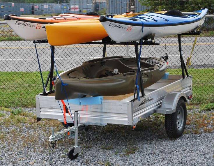 two kayaks sitting on the back of a trailer