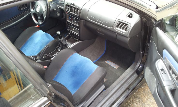 the interior of a car with blue seats