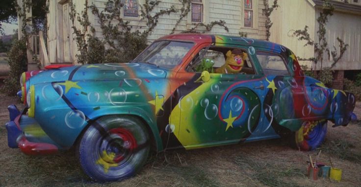 an old car painted with clowns and bubbles