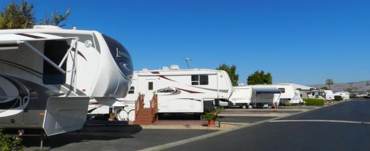 an rv park with several recreational vehicles parked on the side of the road