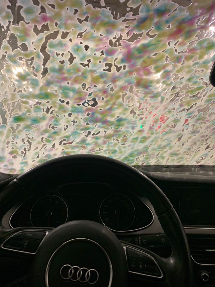 the inside of a car with an artistic ceiling