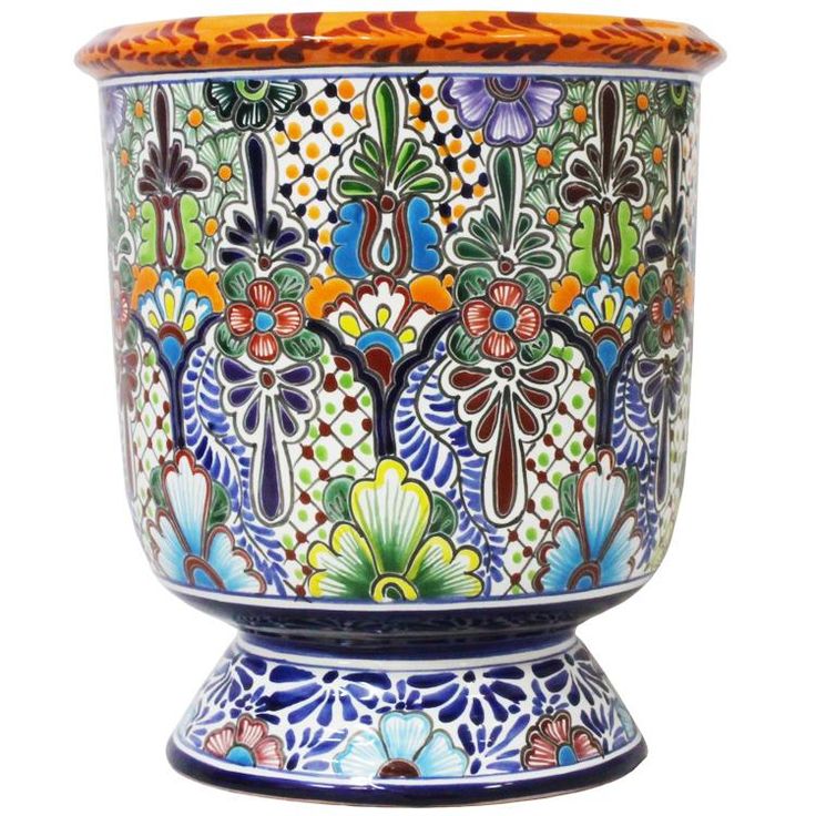 an ornately decorated vase with flowers and leaves painted on it's sides, sitting in front of a white background