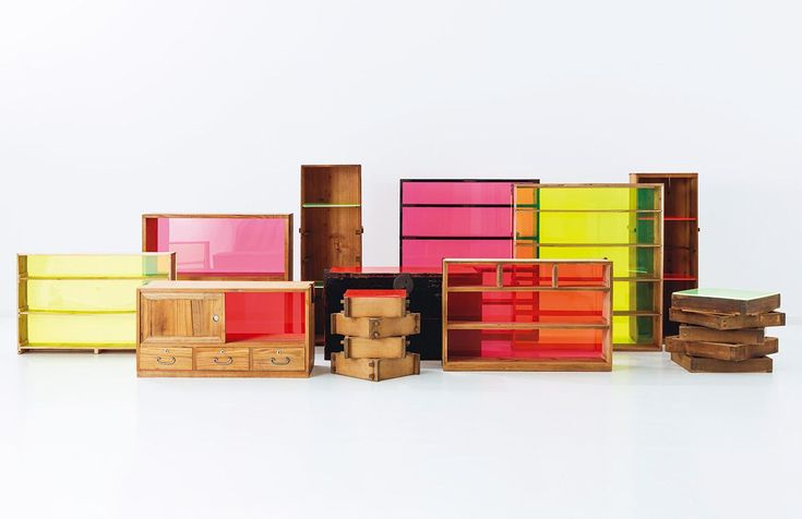 many different colored drawers and boxes stacked on top of each other in front of a white background