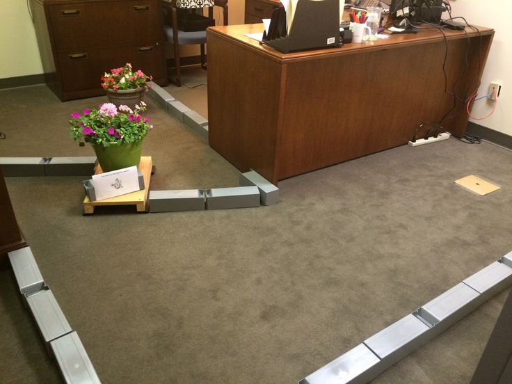 a flower pot sitting on the floor in an office