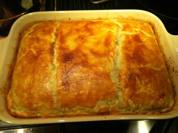 a casserole in a yellow dish on top of a stove