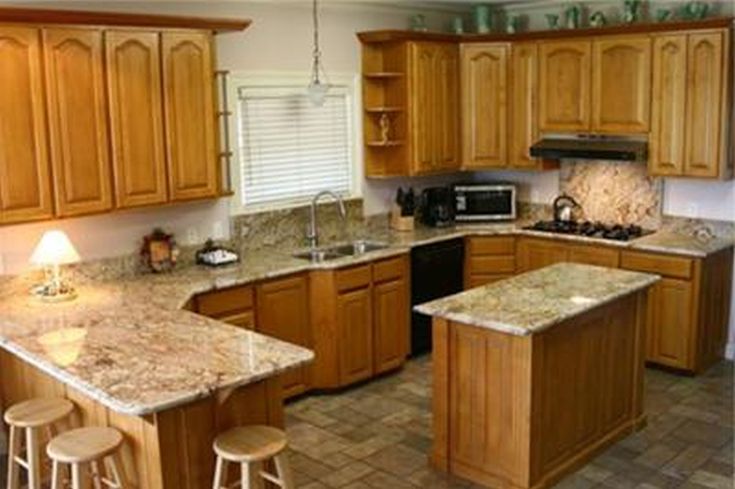 a kitchen with wooden cabinets and granite counter tops