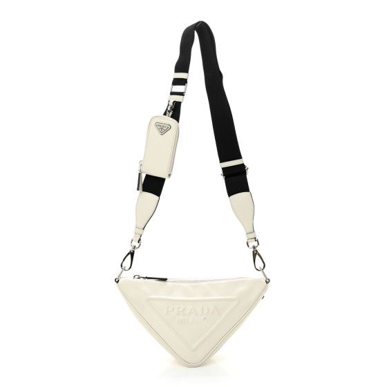 This is an authentic PRADA Grace Lux Triangle Shoulder Bag in White. This stylish bag is crafted of white calfskin leather and is decorated with an embossed Prada logo. The bag features a black nylon shoulder strap and a top zipper that opens to a black logo-jacquard interior. White Chic Calf Leather Shoulder Bag, Chic White Calf Leather Shoulder Bag, White Calf Leather Tote Bag, Elegant White Calf Leather Shoulder Bag, White Calf Leather Shoulder Bag With Removable Pouch, Designer White Calf Leather Shoulder Bag, White Calf Leather Shoulder Bag With Soft Leather, White Calf Leather Shoulder Bag For Daily Use, White Calf Leather Bag For Everyday Use