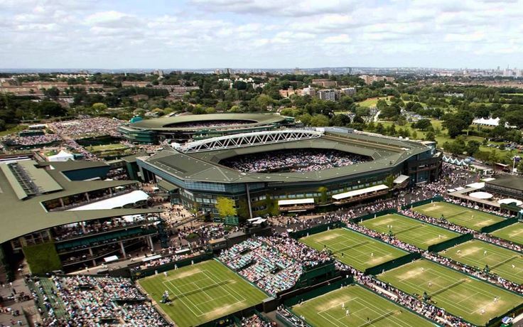 an aerial view of a tennis stadium with many spectators