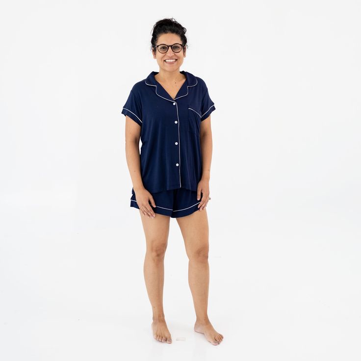 Woman wearing Kyte Baby Women's Short Sleeve Pajama Set in Navy with Cloud Trim Casual Cotton Nursing-friendly Sleepwear, Nursing-friendly Relaxed Fit Sleepwear, Relaxed Fit Nursing-friendly Sleepwear, Family Matching Loungewear Sets With Short Sleeves, Comfortable Nursing-friendly Sleepwear, Blue Nursing Friendly Sleepwear, Family Matching Cotton Sleepwear, Family Matching Cotton Sleepwear For Loungewear, Nursing Friendly Short Sleeve Sleepwear