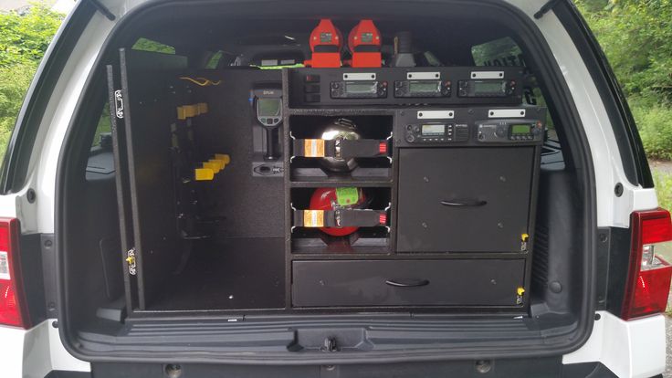 the back end of a white van with its cargo compartment open and tools in it