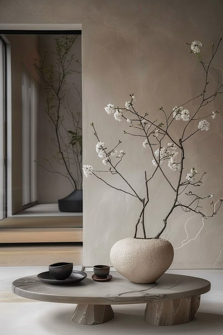 a vase with white flowers sitting on top of a table