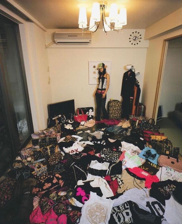 a room filled with lots of clothes on the floor